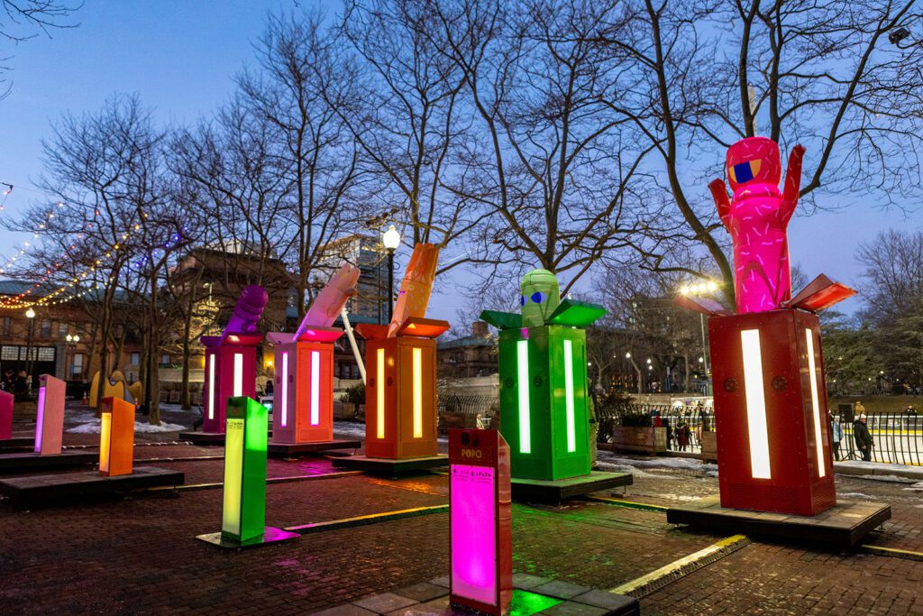 Colorful 'POP!' installation by Gentilhomme at LUMINA, featuring vibrant illuminated sculptures in a park setting at dusk.